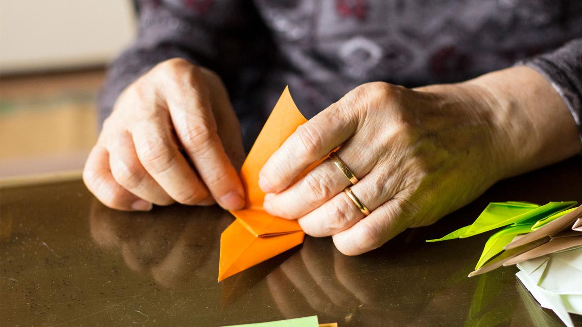 hands folding oragami